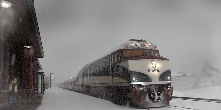 Train arriving at station in the snow